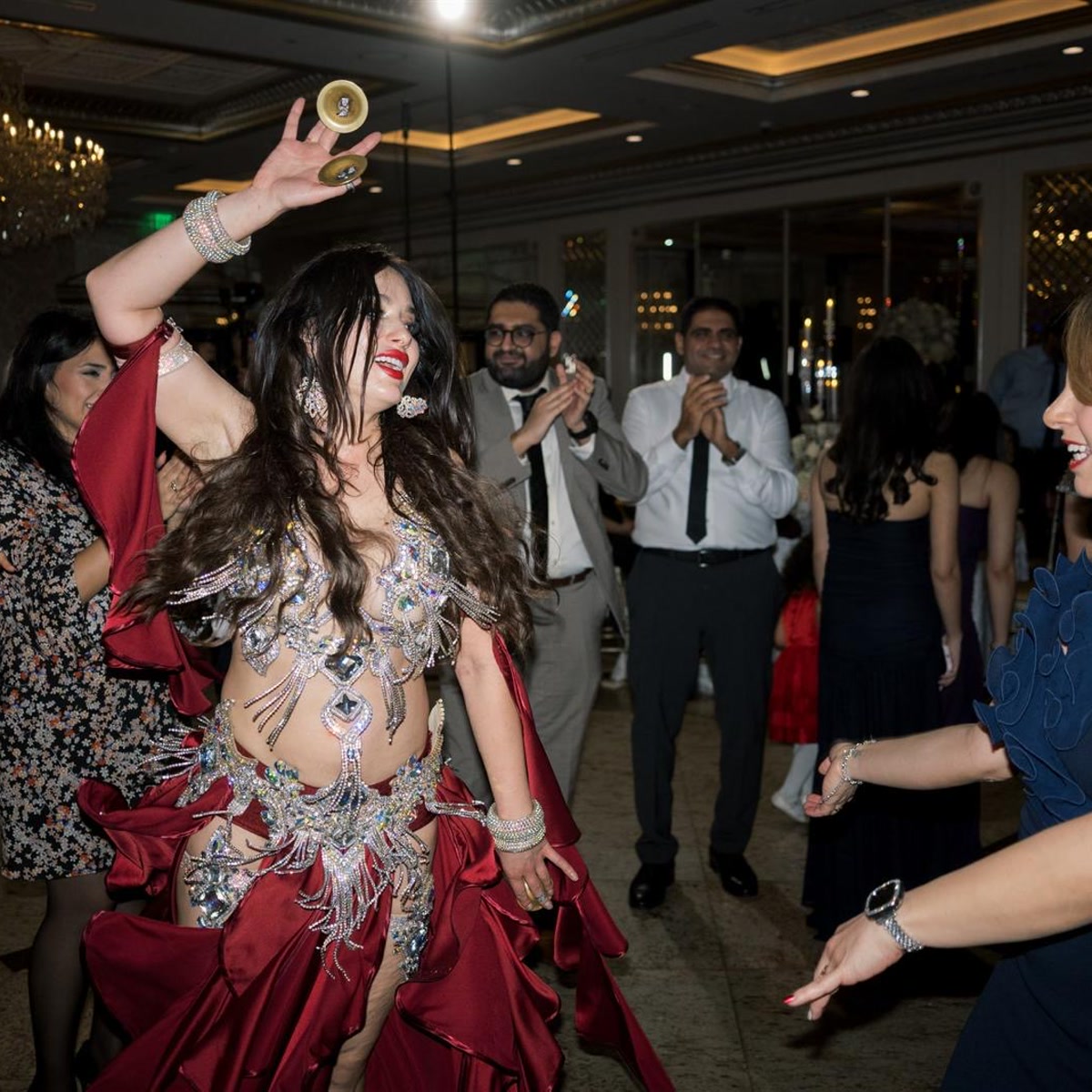 Guests gathered around Ivanna during a live belly dance show