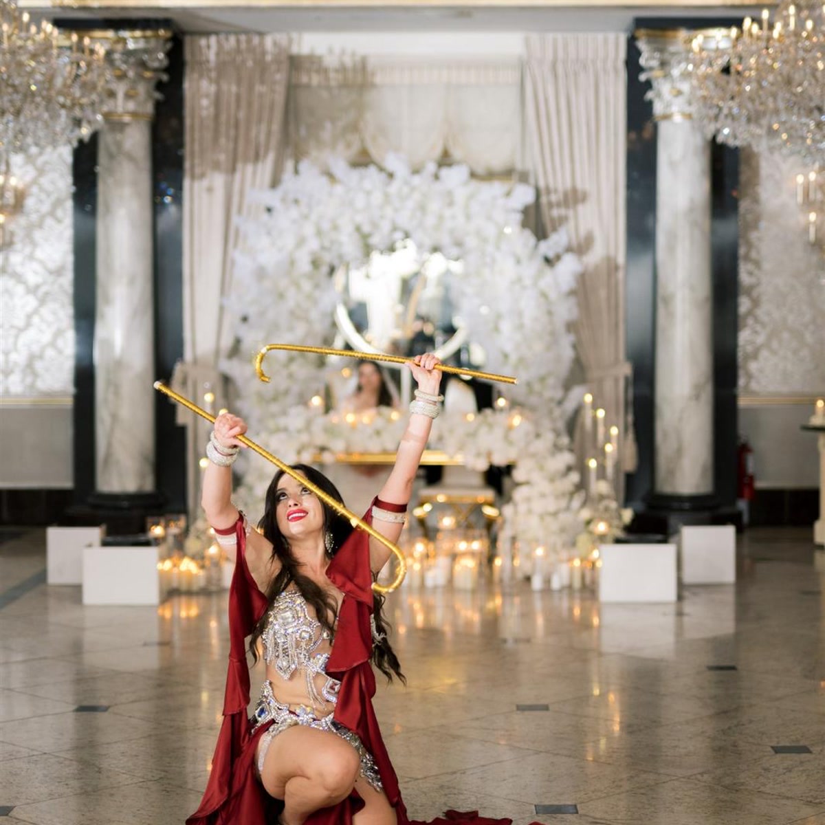 Kneeling cane pose on a marble ballroom floor