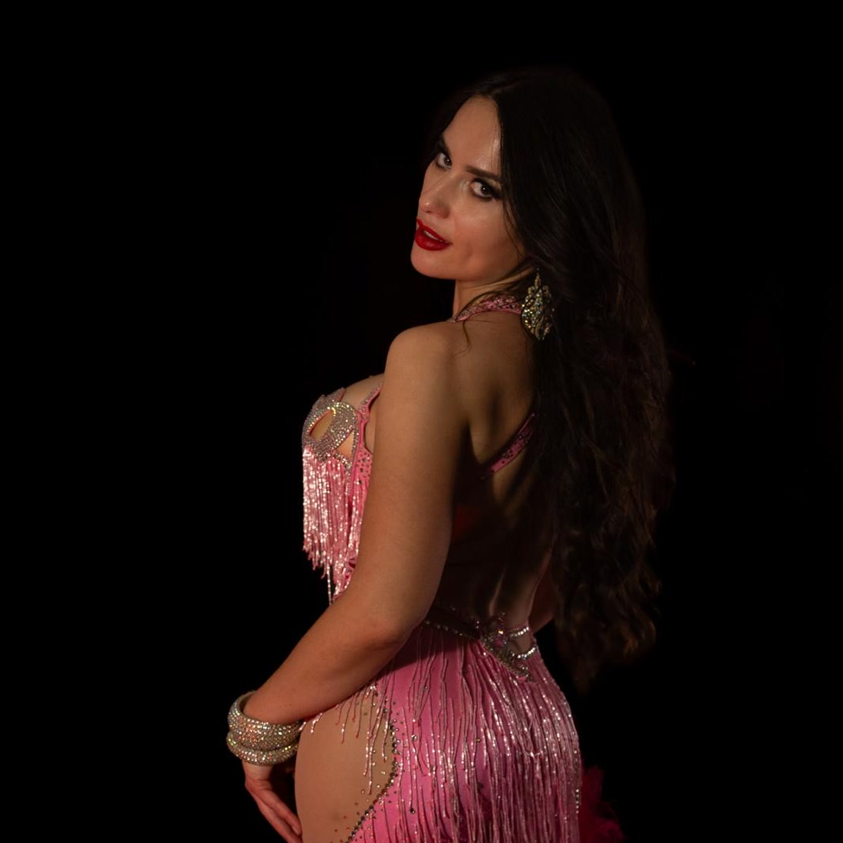 Profile look in a hot-pink fringe costume