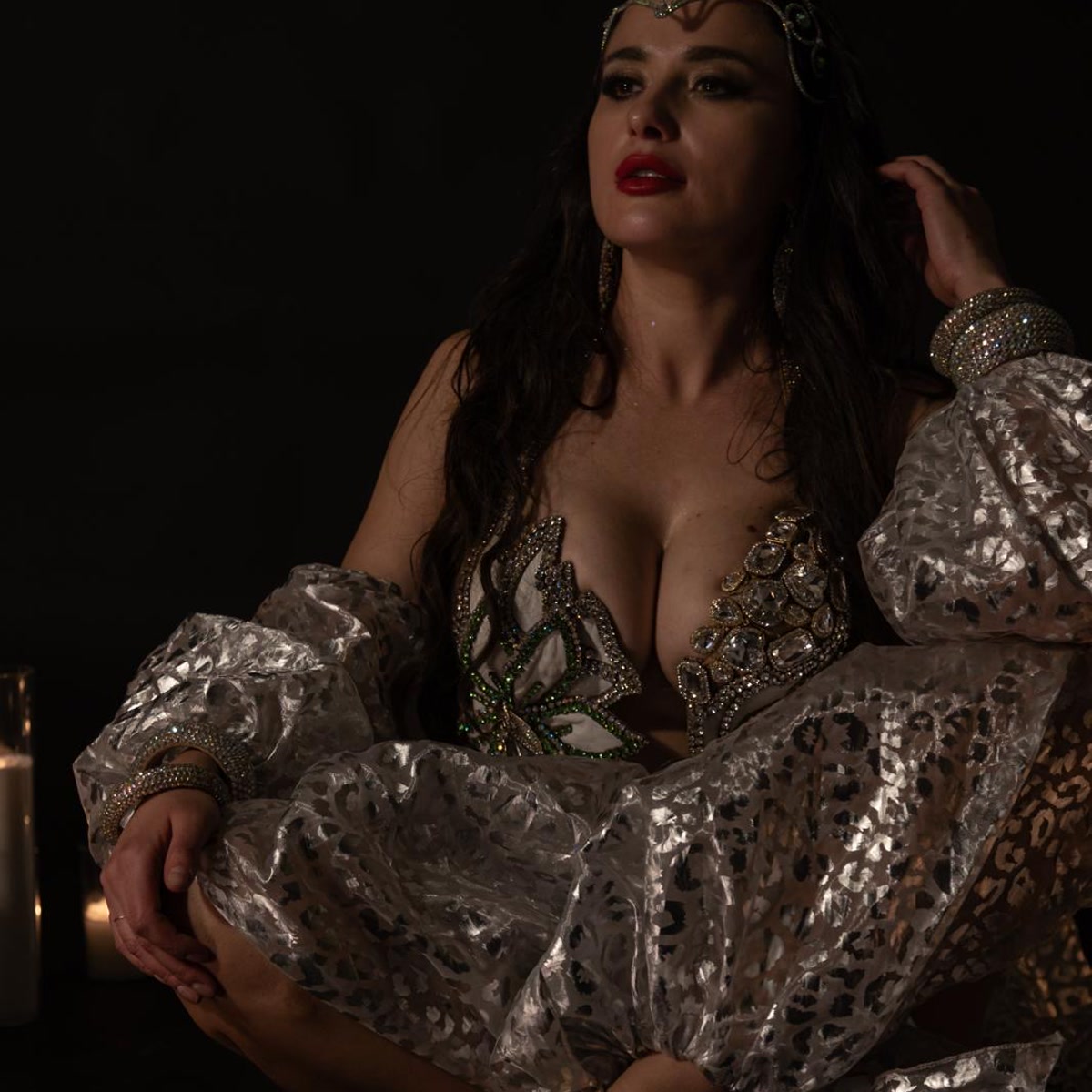 Seated studio portrait in a jeweled metallic costume