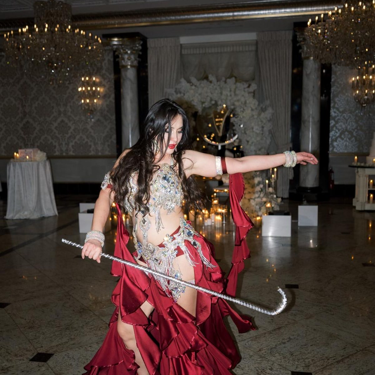 Ivanna performing a Saidi cane dance in a luxury ballroom