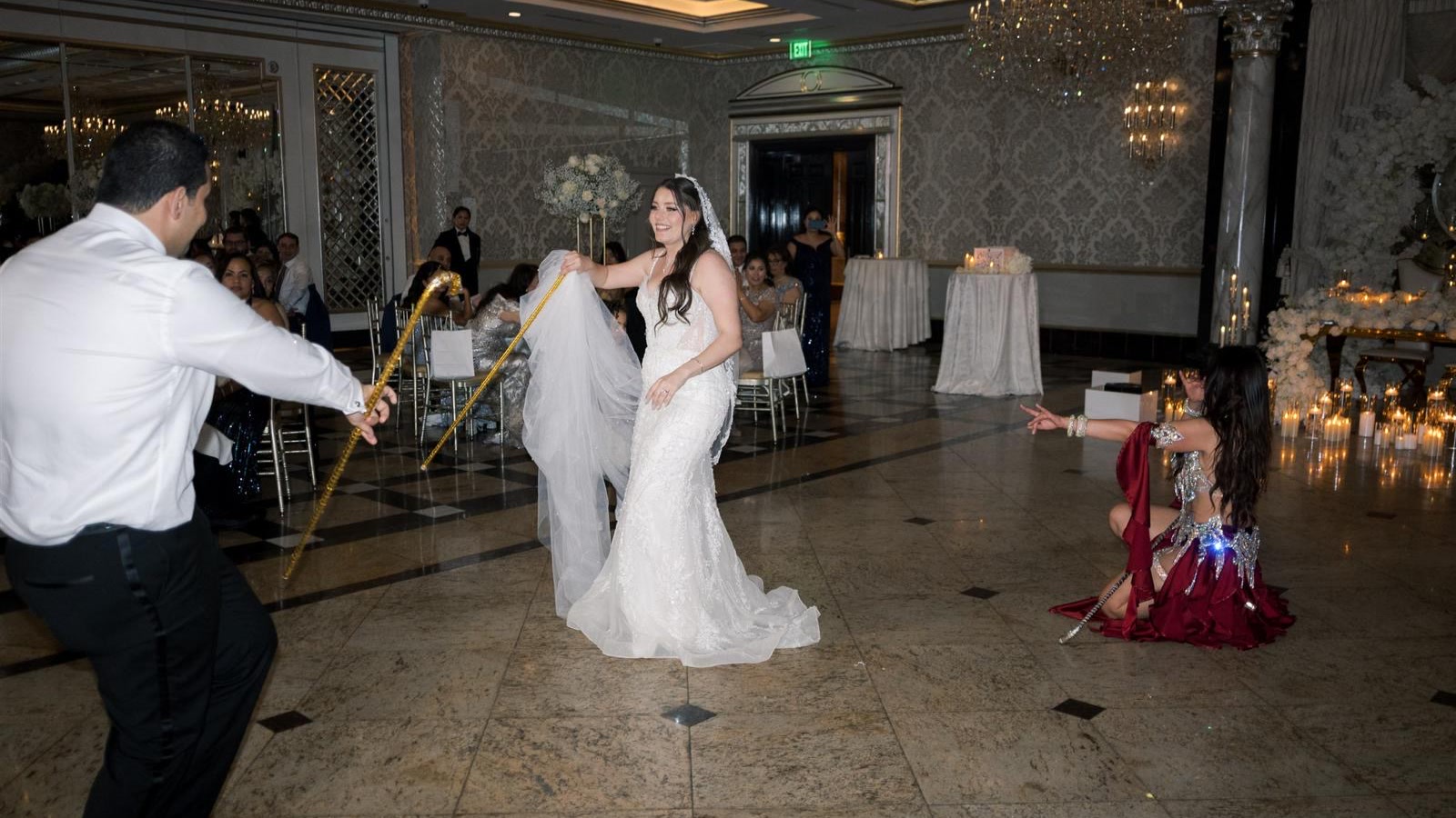 Ivanna kneeling with the bride on a marble dance floor