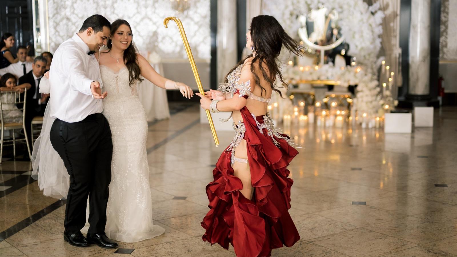 Red ruffled skirt mid-spin for the wedding couple