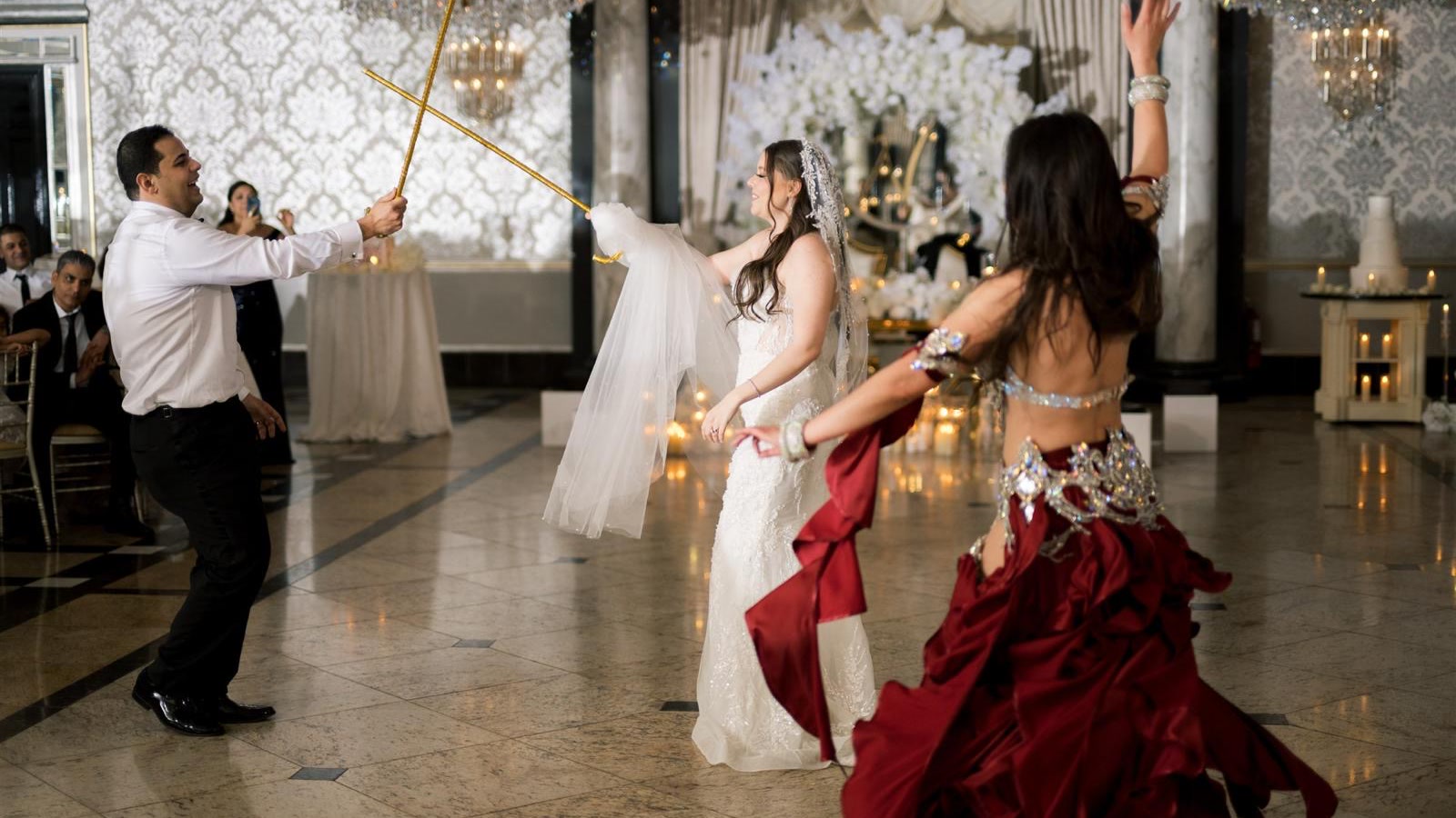 Crossed golden swords with the bride and groom
